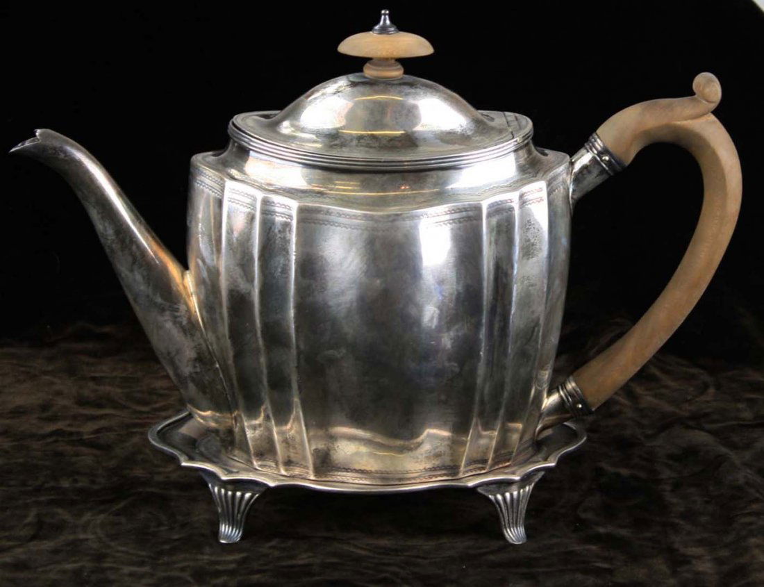 1799-1800 London John Robins sterling silver teapot: and matching neoclassical fluted footed salver trivet both having family crest of pelican and crown 7" x 11.5" x 4", 1" x 6.75" x 4.5" -old repairs, weak spot, dent