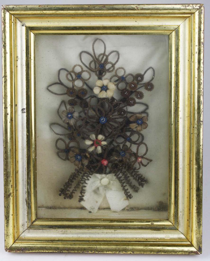 mid 19th c hair wreath memorial in lemon gilt frame: inscribed on reverse "E W Bingham presented by Miss Rhoda Cole", shadow box frame, 12 1/2 inches by 9 1/2 inches