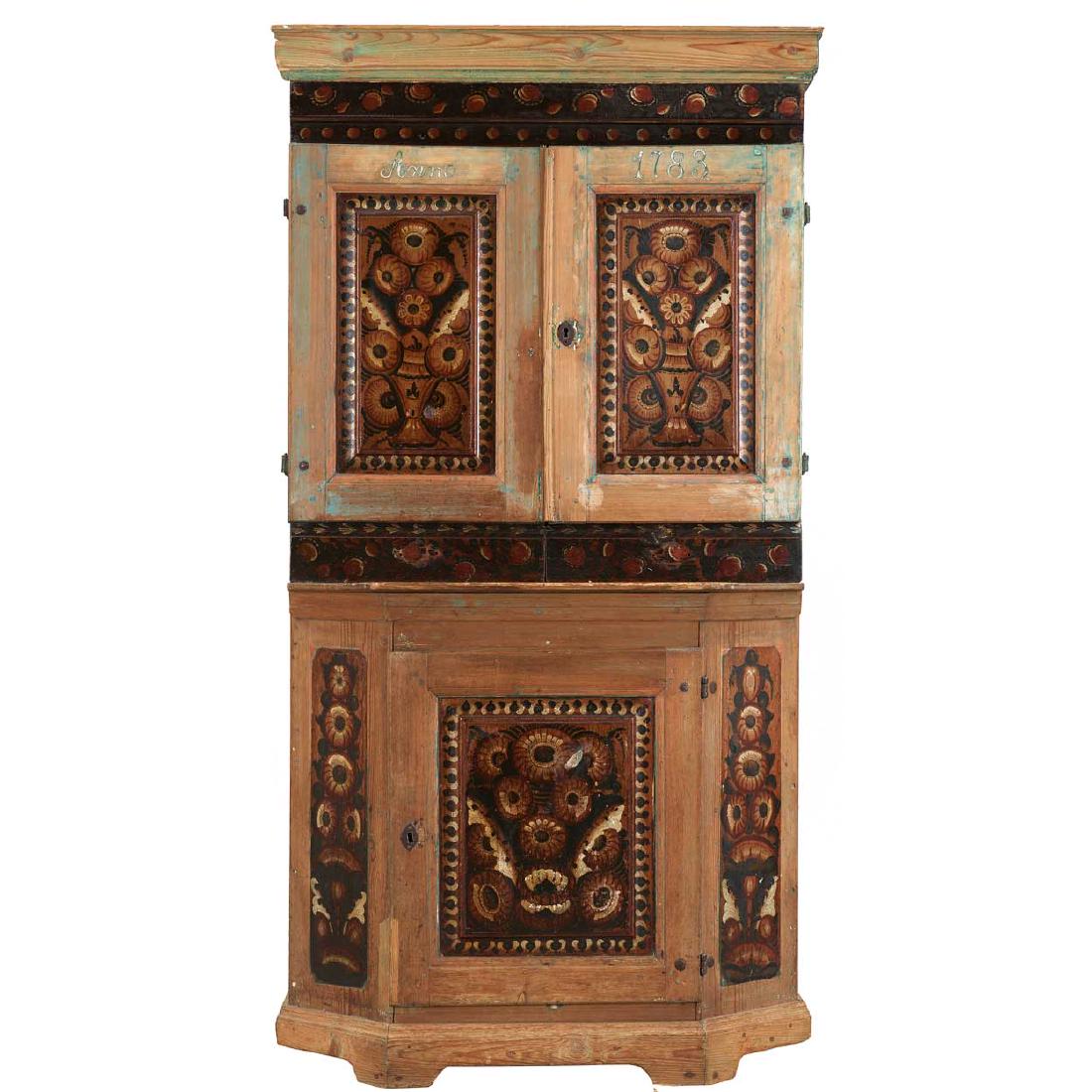 Swedish Dalarna Painted Pine Two-Part Corner Cabinet: A Scandinavian antique, bow front, step-back, corner cabinet with painted folk art decoration. The top has a single door with shelves on the interior above an open niche, above a single door base. It