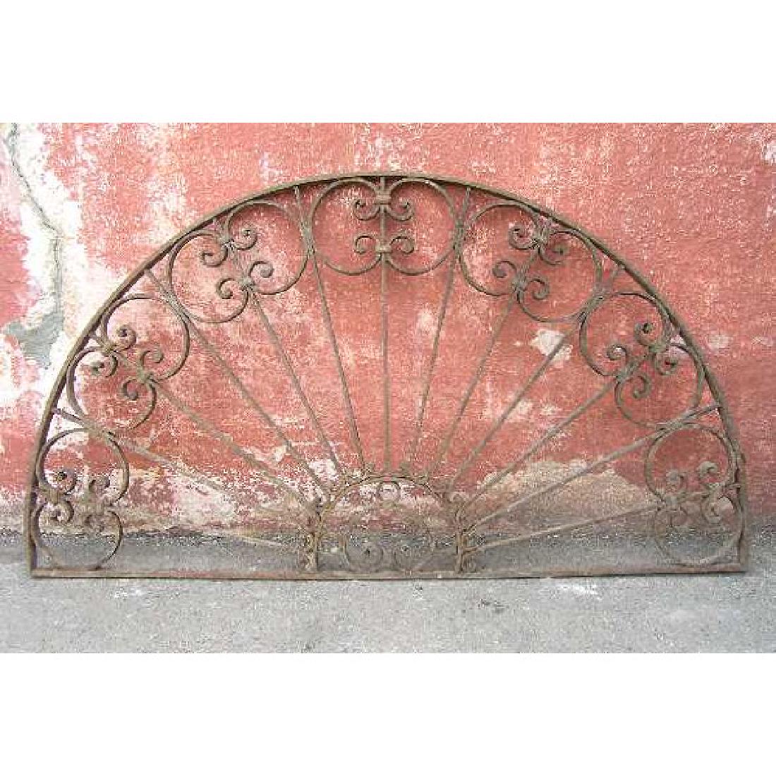 French Colonial Wrought Iron Arched Transom Grille: DATE c. 1890 DIMENSIONS Width 53.5 Height 29 in.