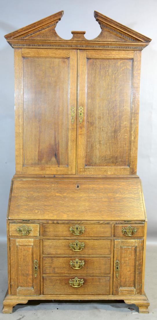 Chippendale Oak Secretaire Bookcase: Antique English provincial deskwith broken top. Blind door cabinet over drop front writing surface with full interior, early hand cut dovetails and original hardware. Dimensions: 87"t x 43"w x 21"d