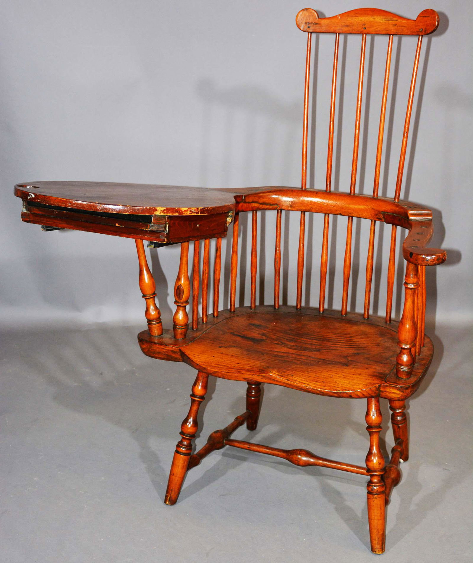 New England 18th Century Comb-Back Windsor Chair: New England 18th Century Comb-Back Windsor Writing Arm Chair with Drawer Branded E.B Tracy. The crest with four spindles above a horseshoe mid-section with writing arm having a sliding drawer.Ca 1780-