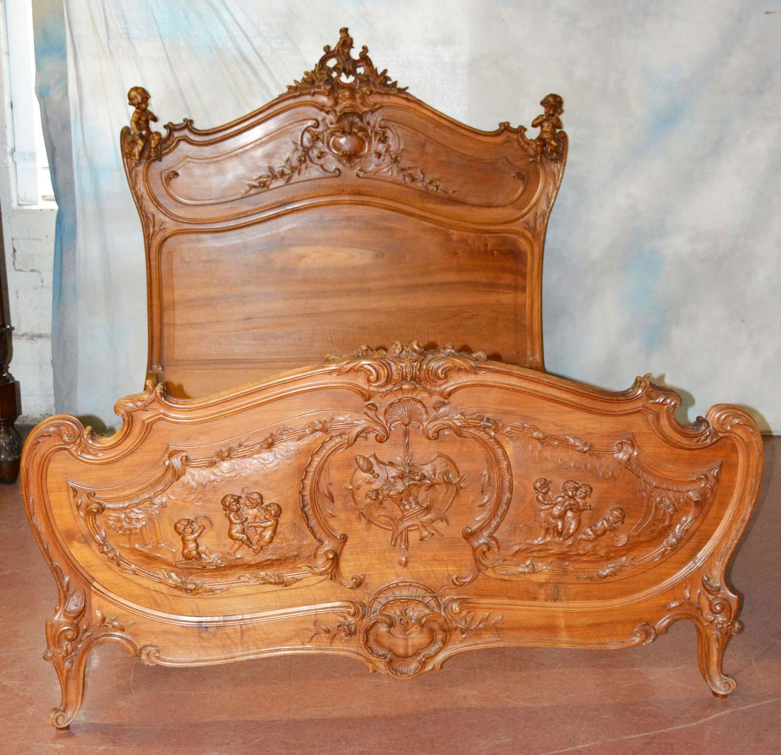 Matching French Louis XV Bed with Cherubs: Matching French Louis VX walnut bed with cherubs sitting on headboard and matching footboard. Dimensions: 65"t x 61"w Date: ca. 1890