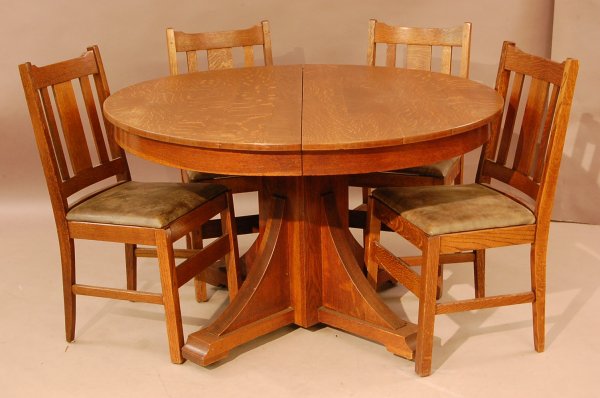 Arts and Crafts Oak Dinning room Set: Arts and Crafts Oak Dinning room Set, with round table, pedestal with carved supports and 4 matching chairs with leather seats, quarter oak , ca 1910, 31"t X 48"L