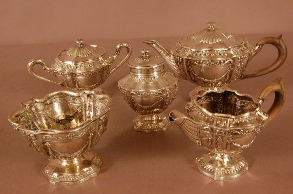 5-piece French Silver Tea Set, Repoussed with swag: 5-piece French Silver Tea Set, Repoussed with swags and leaf decoration Teapot covered sugar, tea canister, milk jug, lemon bowl. Wood Handles. The Marks indicate late 19th Century, provincial France