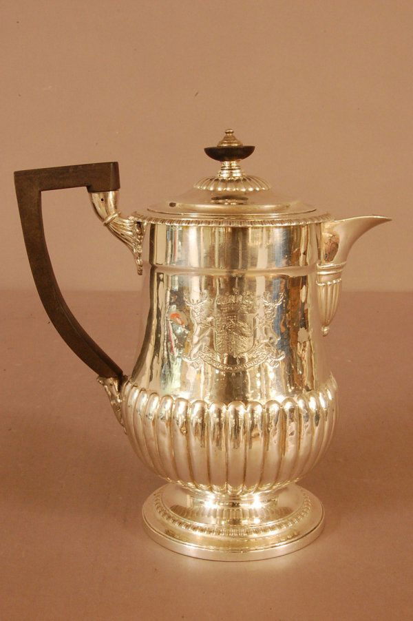 George III Silver Coffee Pot with lid. Gadroon ri: George III Silver Coffee Pot with lid. Gadroon rim and base. Plain body with melon ribbing towards base, raised foot. Latin Motto--"Through Trial to Triumph". Boxwood handle. Lid is bent. Hallmakrd on