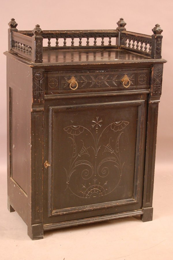 Aesthetic Movement ebonized side cabinet with turn: Aesthetic Movement ebonized side cabinet with turned spindel gallery, one drawer, one door. Appears to be of cherry wood construction. 45"T x 30 1/2"L x 19"D ca. 1875