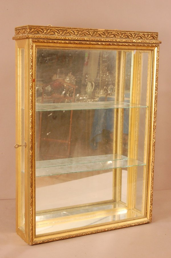 French Gilted Hanging Wall Cabinet. Key signed Dc: French Gilted Hanging Wall Cabinet. Key signed DcDonick Freres courtrai. Mirrored Top, back and bottom. 1 door, 30"T x 22"L x 5 1/2"D ca. 1900