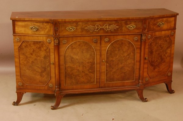 Sheraton Style Walnut Sideboard with step out fron: Sheraton Style Walnut Sideboard with step out front. Burled Panels in Drawers & doors. 2 columns in front, carved legs. 35 1/2"t x 66"w x 21"d ca. 1920