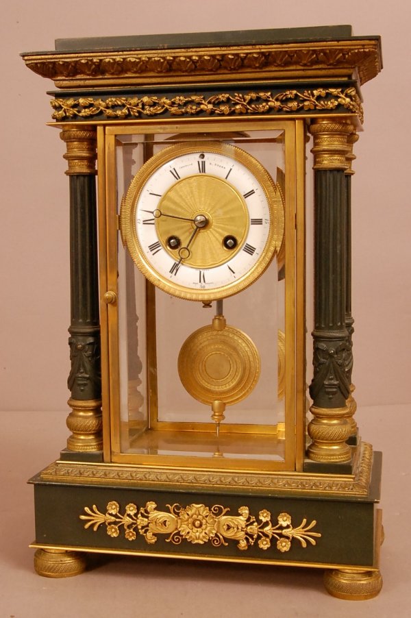 French 4 Column Bronze Shelf Clock, Porcelain & Bro: French 4 Column Bronze Shelf Clock, Porcelain & Bronze face signed Theodors B. Stark, New York. Dore Bronze on Patined Bronze base & columns. Beveled Glass on all sides, works signed A-1 quality. Made