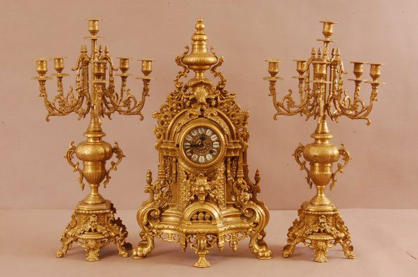 3 Piece Bronze French Clock Set with matching candl: 3 Piece Bronze French Clock Set with matching candleabras. Porcelain numbers on dial, German movement. 2 Bell Strike. Clock is 24" t x 14"w x 5"d.; Candleabras are 24"t x 14"w x 5"d