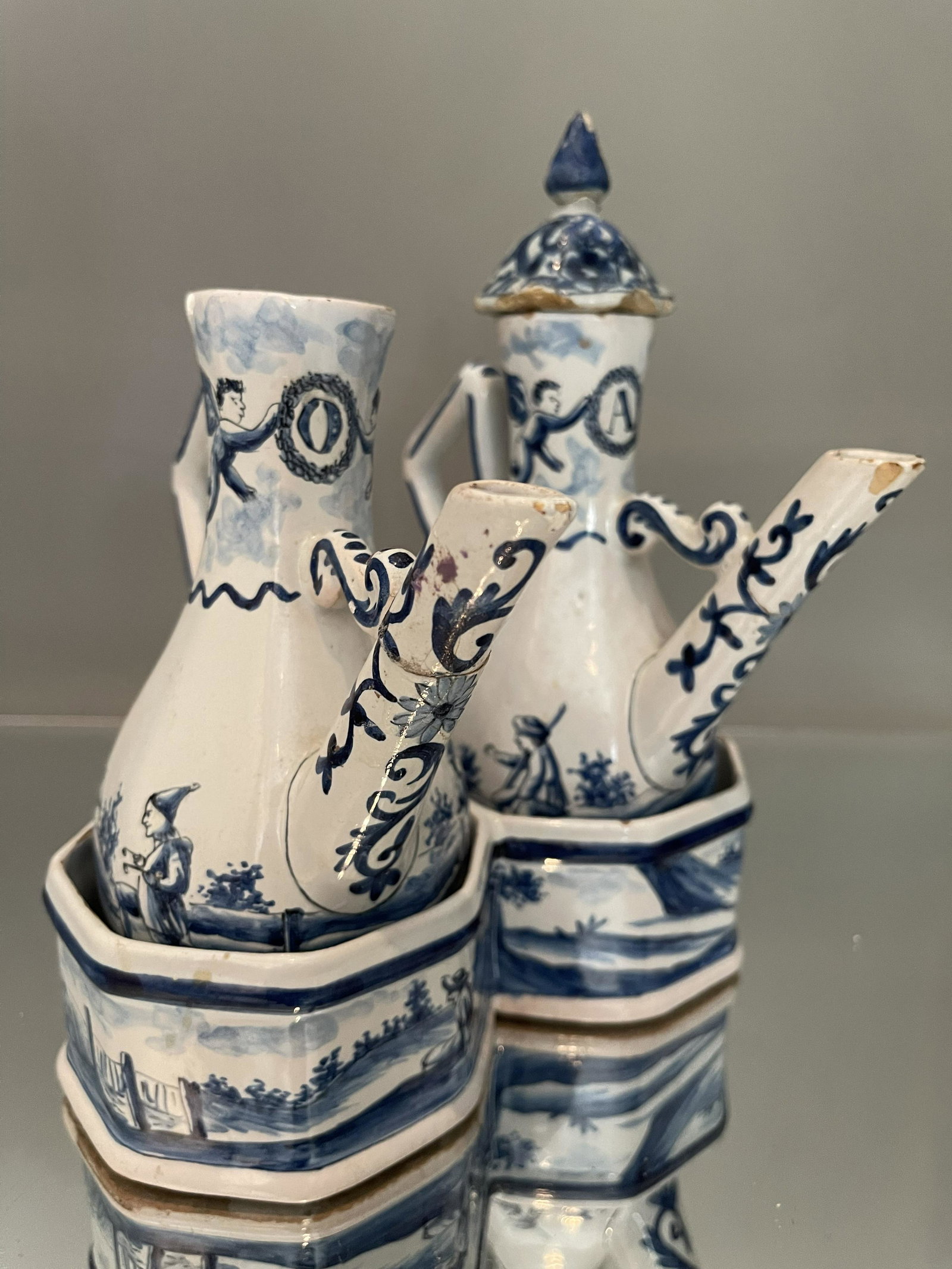 Dutch Delft Vinegar and Oil Containers: Period: 18th century Origin: Holland Description: blue and white Dutch scenes. Dimensions: 9" x 9"