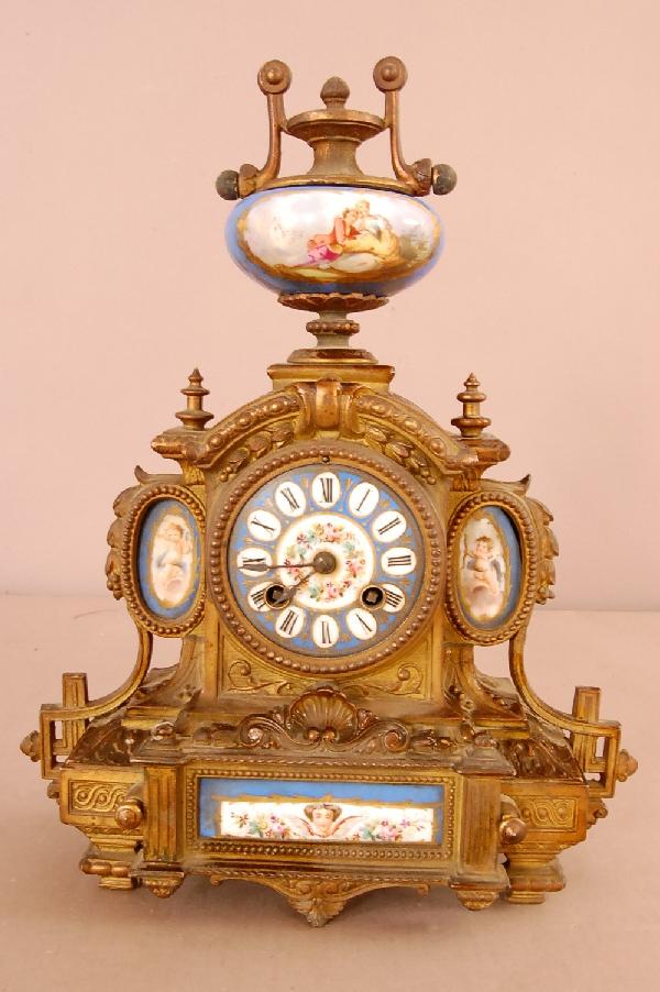 Seves style French Bronze Clock: French Louis XIV style shelf clock with enameled porcelain dial, scenic porcelain finial, cherubs on side panels, floral panel in base, time & strike. Works signed Jres C-1 Med Drokneg. Case #9. P.H. 