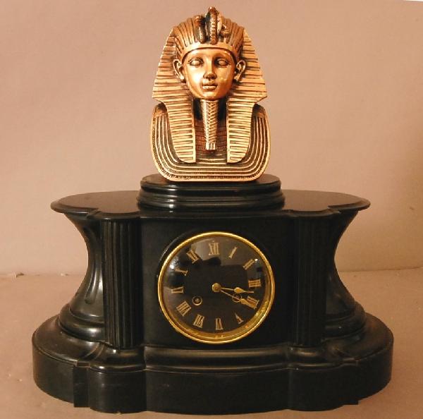 French Mantel Clock: French Slate Mantel clock with Egyptian copper bust of King Tut. Black Porcelain dial with roman numbers. Time & strike. 17" t x 17" w x 7"d ca. 1880