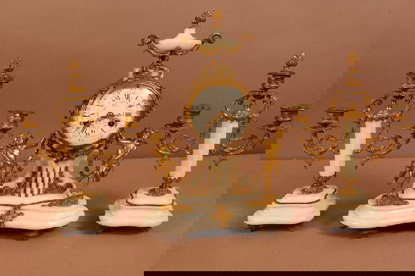 French Dore Bronze Louis XVI Style Clock Set. Urn S: French Dore Bronze Louis XVI Style Clock Set. Urn Shaped Finial and 2 Angels Standing on Sides. Porcelain Dial, white marble base & 2 matching candleabras. Works Signed A-1 Japy Freres. 15" t x 9 1/2"