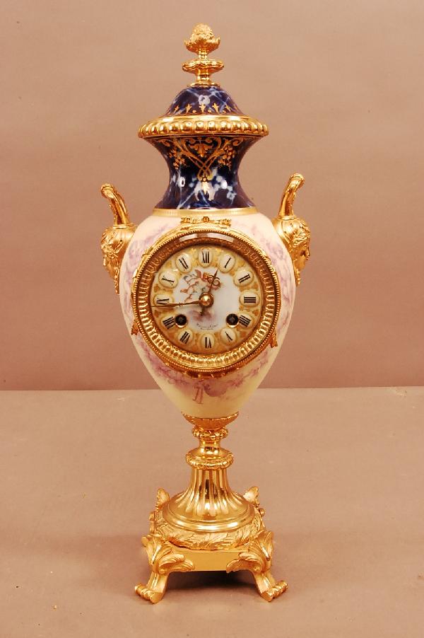 Tiffany Dore Bronze & Porcelain Louis XV style man: Tiffany Dore Bronze & Porcelain Louis XV style mantel clock, Enameled Porcelain Dial. Works signed Tiffany & compy. Manti-Medelle de Bronze. 18" t x 6" w x 5 1/2" d. Ca. 1900