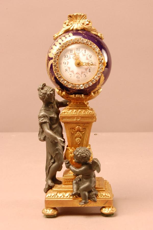 French Dore Bronze & Porcelain Ladies Dressing Roo: French Dore Bronze & Porcelain Ladies Dressing Room clock. Enameled Cobalt Blue case. Porcelain decorated dial, encrusted with stones. 2 Children on base. 7" t x 3" w x 2 1/2" d. Ca. 1890