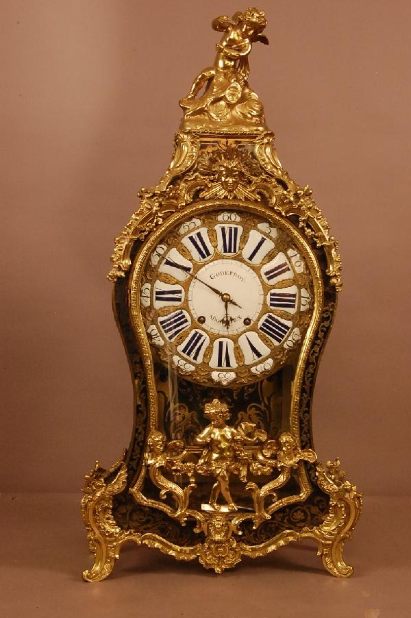French Louis Bronze XV Shelf Clock. Boulle inlaid: French Louis Bronze XV Shelf Clock. Boulle inlaid case with standing cherub in crest & door. Bronze & porcelain dial with roman numerals. Works signed Godefroy A Bordeaux. 37" t x 18 1/2" w x 6 1/2" d