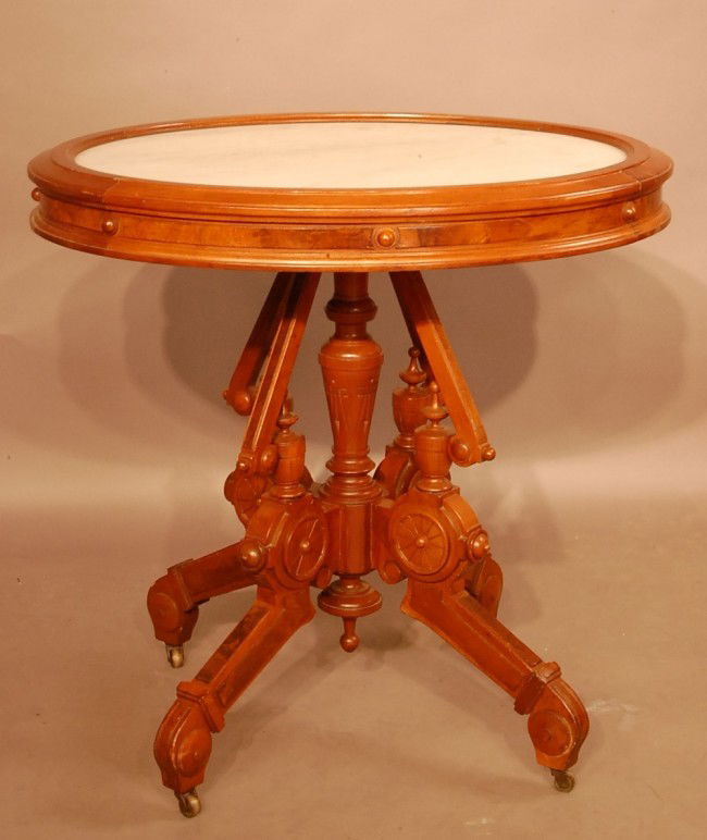 Renaissance Revival style Walnut Parlor table. Ov: Renaissance Revival style Walnut Parlor table. Oval picture frame molding surrounding marble top. Burled panels on aprons, turned & carved center pedestal & finial on 4 legs with applied burl panel. 3
