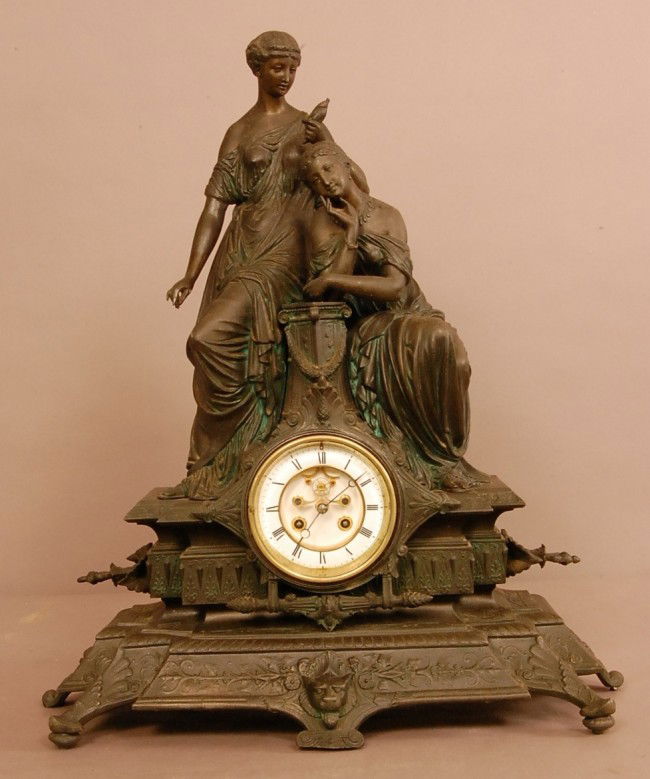 French Figural Renaissance Revival style mantel cl: French Figural Renaissance Revival style mantel clock, 2 women leaning on pedestal Patined spelter statue and base. Clock has porcelain dial with open escapement. Time & strike. Signed Medaille Lmant