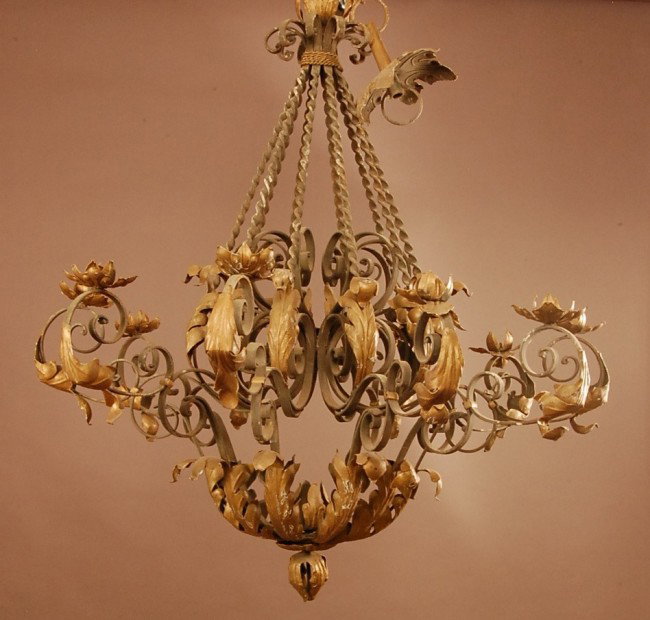 French Provencal 10 arm Iron light fixture. Wroug: French Provencal 10 arm Iron light fixture. Wrought iron swivel supports. 45" t x 40" w x 40" d Ca. 19910