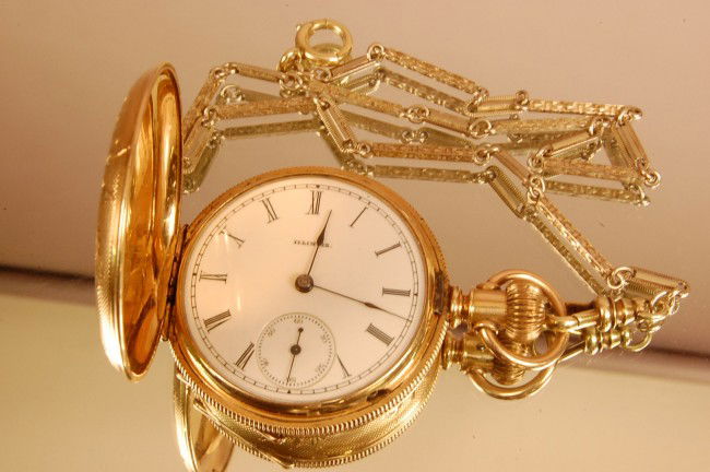 Illinois Watch Co. Hunting Case Pocket Watch. Le: Illinois Watch Co. Hunting Case Pocket Watch. Lever set, 11 Jewel, 14 Kt gold chain. Watch 2 1/4" L, Chain 12" L