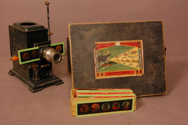 Cinematographer--Kinematograph projector & slides.: Cinematographer--Kinematograph projector & slides. 11 1/2" t x 8 1/2" w x 5" d Ca. 1900