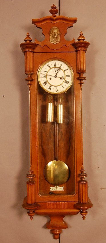 Vienna 2 weight R.. Walnut regulator clock with ro: Vienna 2 weight R.. Walnut regulator clock with rounded top & bottom "Cookie" corners. Victorian bust in crest. Porcelain dial, time & strike with second hand. 48" t x 14" w Ca. 1880