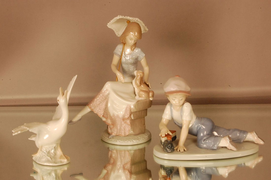 Llardo Porcelain statues. Girl with Parasol & dog.: Llardo Porcelain statues. Girl with Parasol & dog. 8" t x 7" w; Swan 6" t x 6" w. Boy with train 8" l x 6" t.