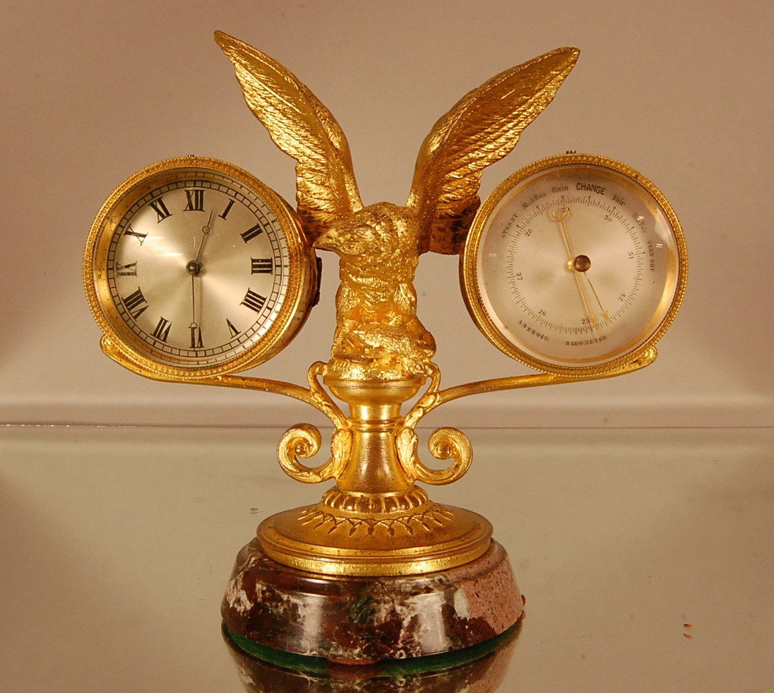 French Dore Bronze Eagle 2 Function desk set, with: French Dore Bronze Eagle 2 Function desk set, with winged eagle standing on nest with French Pinwheel Clock on one side & Barometer on other on marble base. 8" t x 8" w x 4" d. Ca. 1900