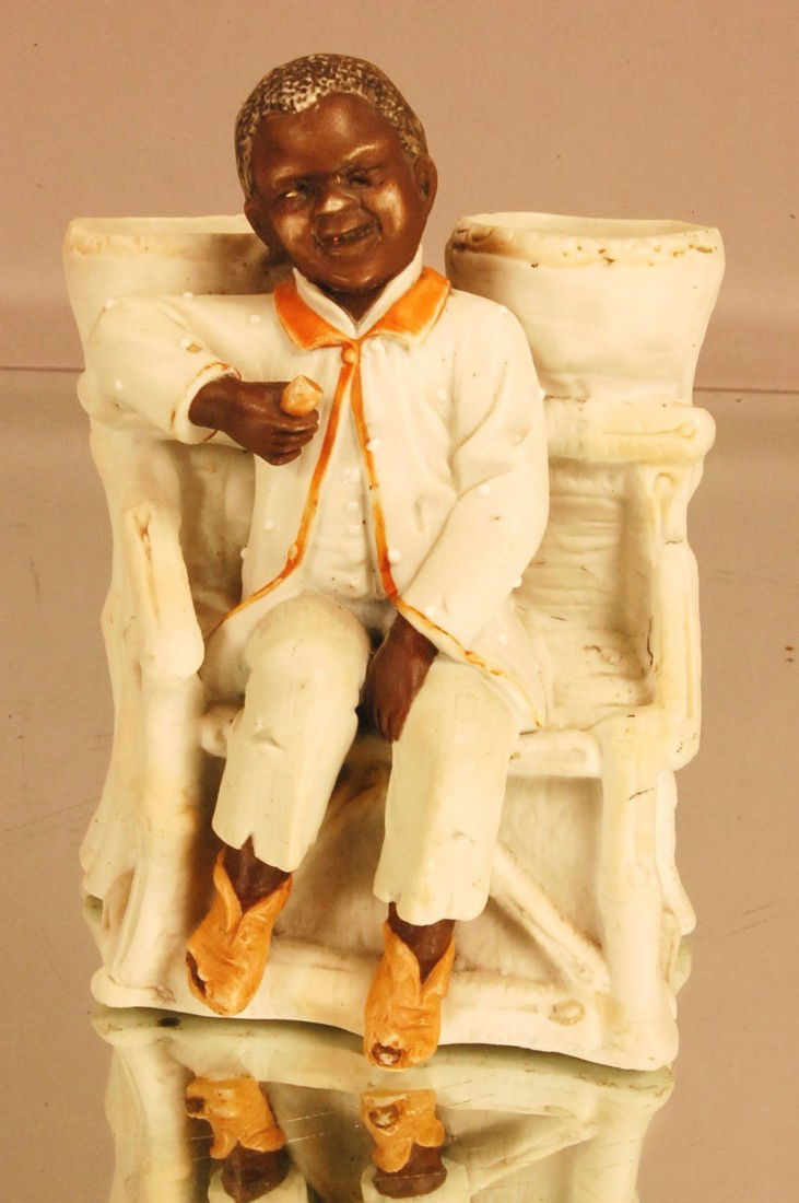 Bisque Figural: Black man sitting on bench. 6" t x 5" w x 3" d Ca. 1900