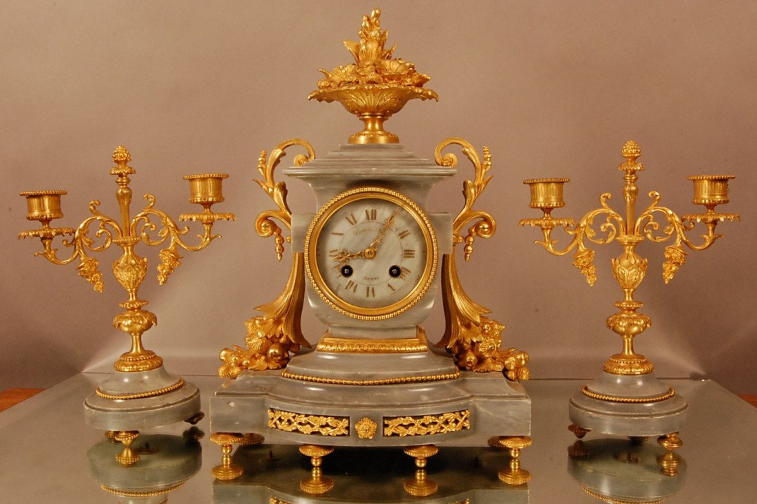 French Louis XVI style Dore Bronze & Marble Clock : Floral center piece on top. Finely detailed cornucopia vases on sides. Unusual Blue Bray toned color marble base. Marble dial signed Trouville A. Amour. Time & strike. Jappy Freres mount with 2 matchi