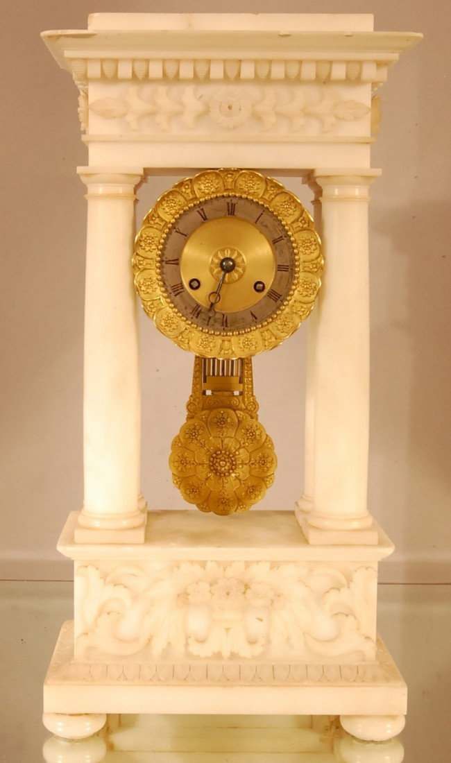 Early French Empire Style Marble Clock: Floral carved top & bottom with 4 columns. Embossed Dore Bronze dial & pendulum. 9" w x 17 1/2" t x 5" d. Ca. 1860