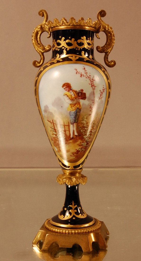 French Serves style urn: Artist signed. Landscape on front. Floral design on back. Dore Bronze mounts & base. Signed France on bottom. 8" t x 3" w Ca. 1900