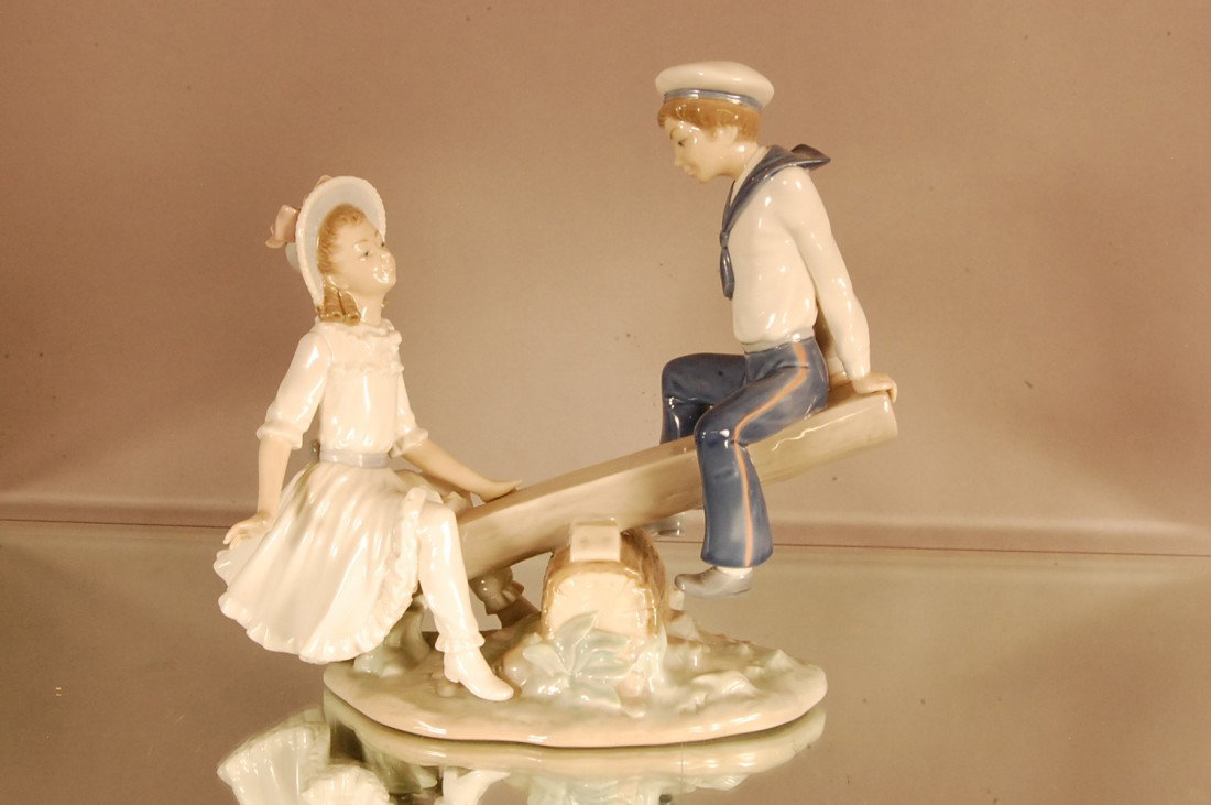 Lladro Statue of boy & girl on teeter-toter: 9" t x 10" l