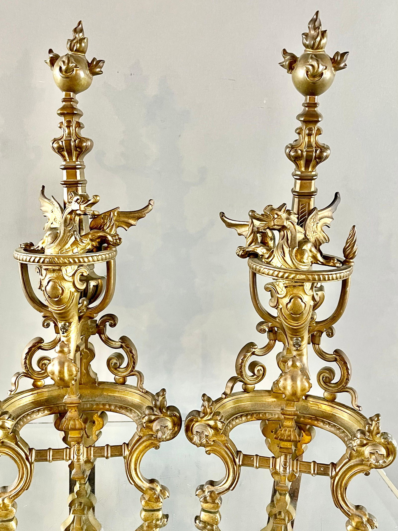 Pair of French Regency Bronze End Irons: ca. 1900 Heavily decorated with winged dragons on footed base. 22”t 9” w