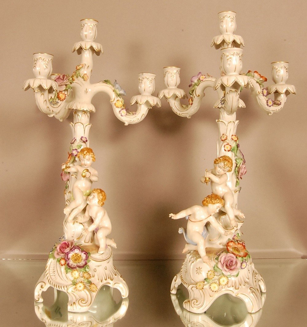 Pair of German Porcelain Figural 3 Arm Candelabras: Cherubs playing in center, applied floral decorations. 21"t x 12" w. Marked Schienholz German, Ca. 1920