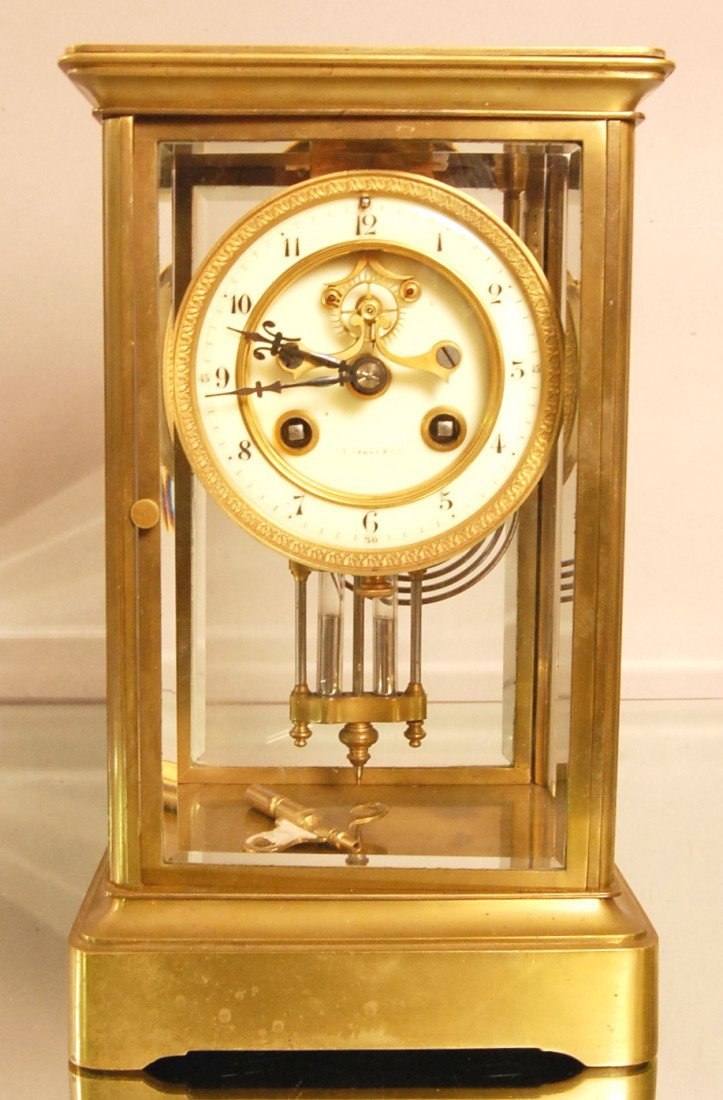 Tiffany & CO. Crystal Regulator Shelf Clock: Bronze case with beveled glass on all sides, porcelain dial with ressessed open escapement, Time & Strike. Works signed Marti. France, Ca. 1890