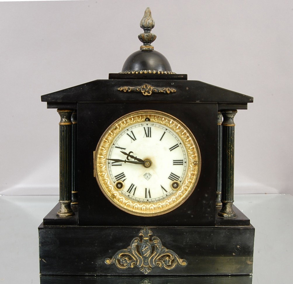 Ansonia Empire Style Iron mantel clock: Porcelain dial, 4 column, time & strike. 14" t x 10" w. Ca. 1890