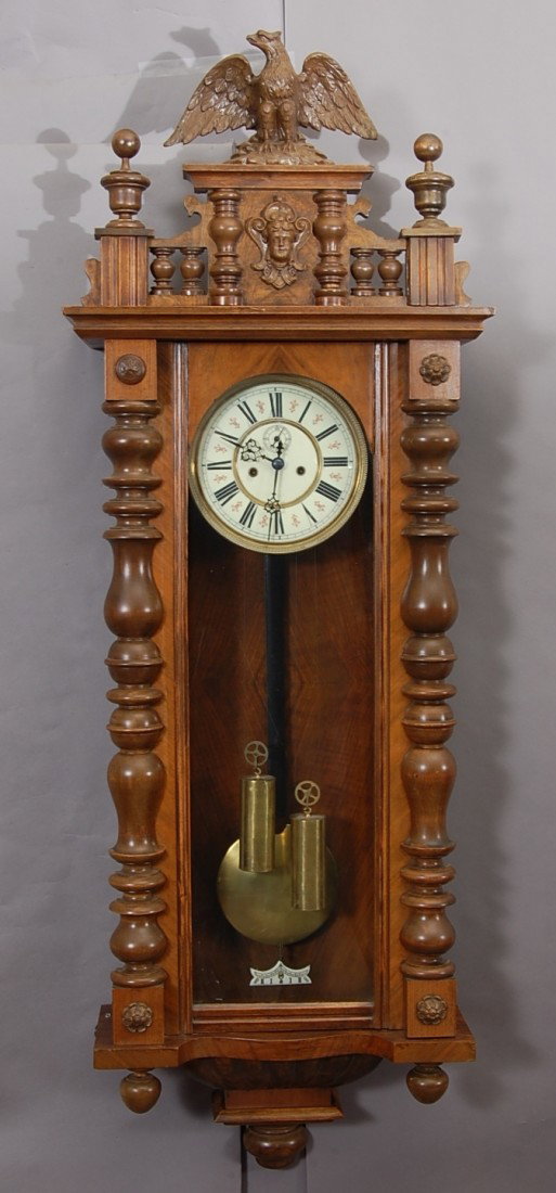 Gustav Becker 2 weight Vienna Regulator: Walnut Case, with eagle in crest, turned 1/2 columns on sides. Porcelain dial with second hand. 52" t x 17" w. Ca. 1880