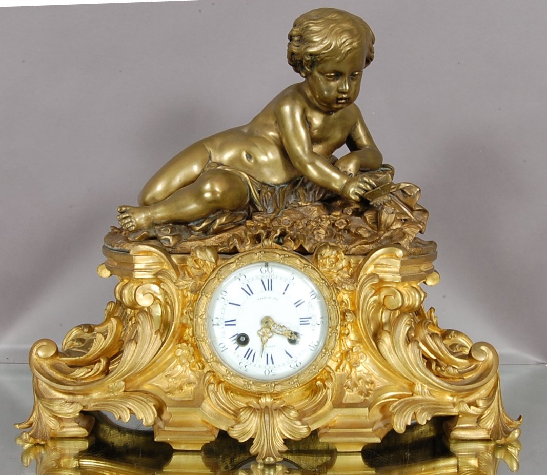 French Louis LX Dore Bronze Figural Mantel Clock: Porcelain Dial with Blue numerals. Raingo-Freres Movements. Paris. Ca. 1870 16" t x 18 w