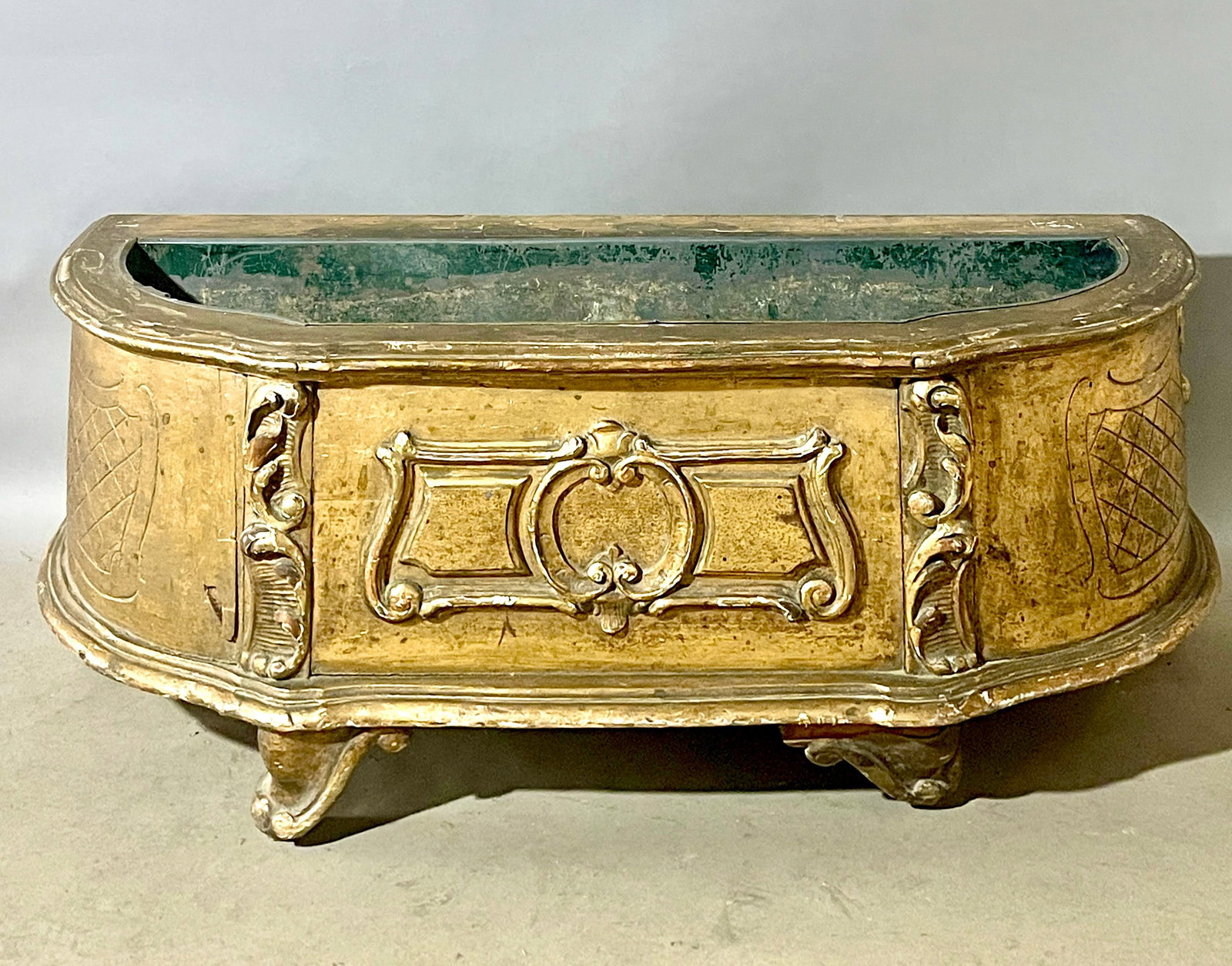 French Louis LXV Giltwood Jardiniere: Gilted and carved on its front and sides. With the original tim liner. Size: 15"t x 40"w x 15"d Ca. 1890.