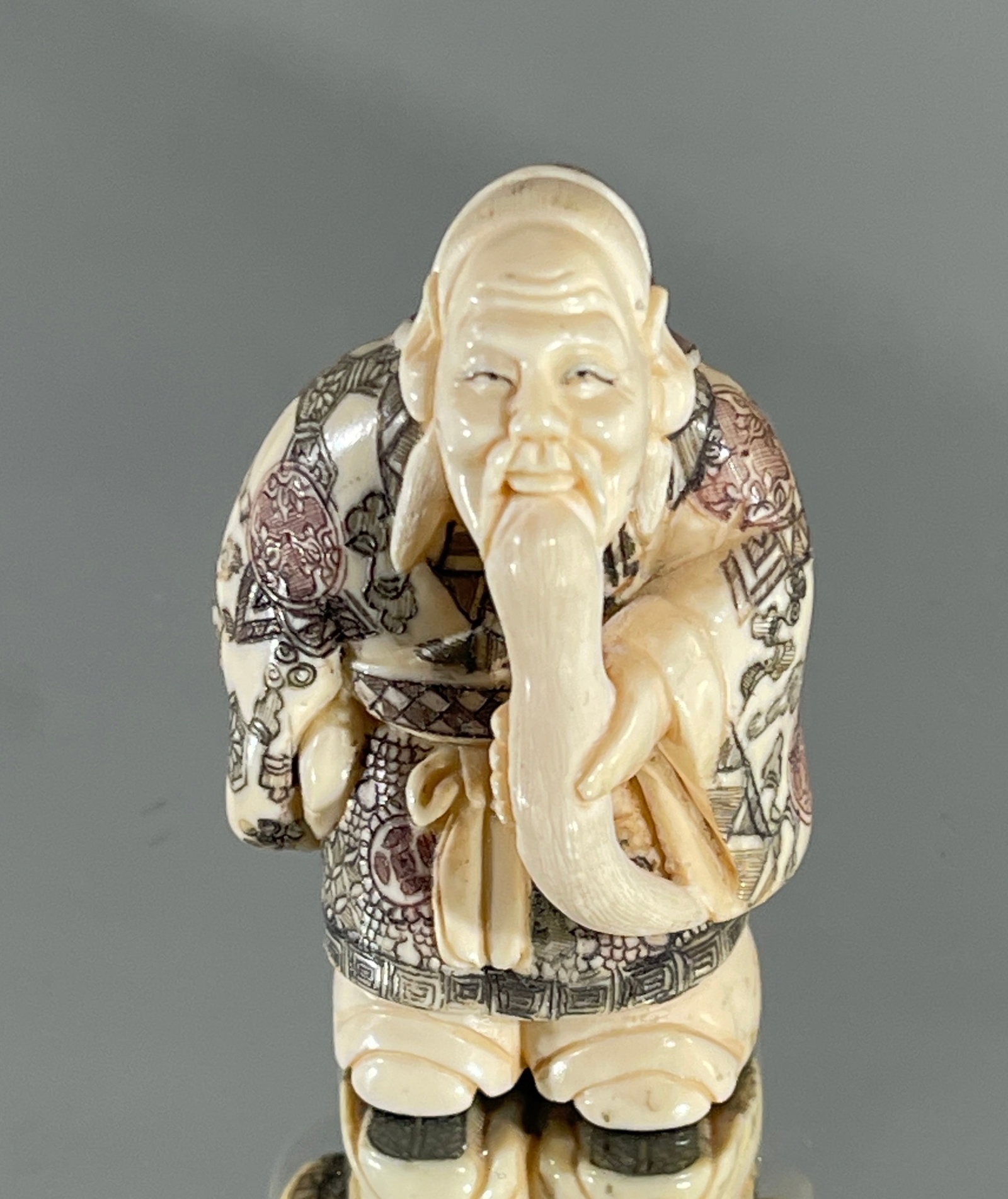 A Fine Japanese Netsuke a Hunched Old Sage Okimono: Old sage Okimono, signed on bottom, walrus tusk. Provenance: Purchased from a San Fransisco dealer by a Denver, Colorado collector. Ca. 19th century. Size: 2"t.