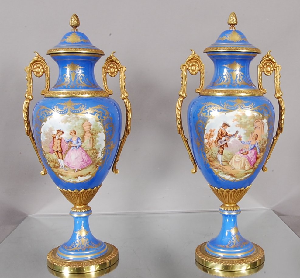 Pair of French Lois XV style Sevres Urns.: Hand decorated with Romantic scenes. 22" t x 10" w.