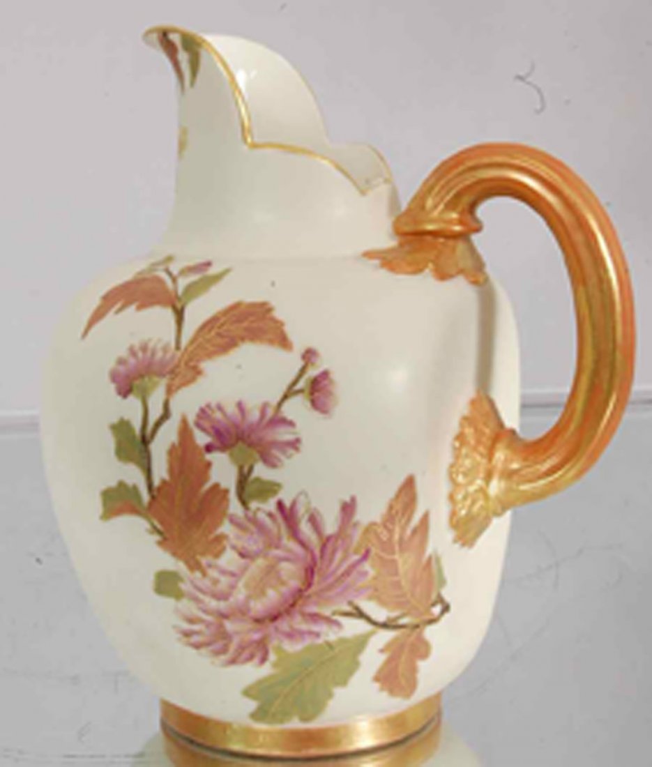 Royal Worchester Cream Pitcher: Hand painted floral decorations. Gilt trim. 7" t x 6" w. Signed on bottom. Ca. 1890