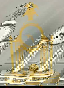 French 19th Century Louis XVI Clock: Marble and ormolu portique clock, enamled porcelain dial, signed Paris, two columns decorated by finials, top crown is an ormolu floral basket with two love birds, all original gilt, clock is complete