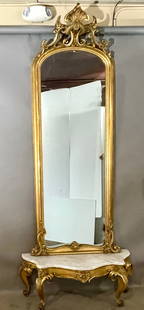 Fabulous French LX Carved Gilt Pier Mirror: With arched pieces and floral crest above arched mirror to a scrolled corner base, white marble top console table on filt wood & cabriole legs, 112"t x 16"d x 46"w, original label on back from Jones &