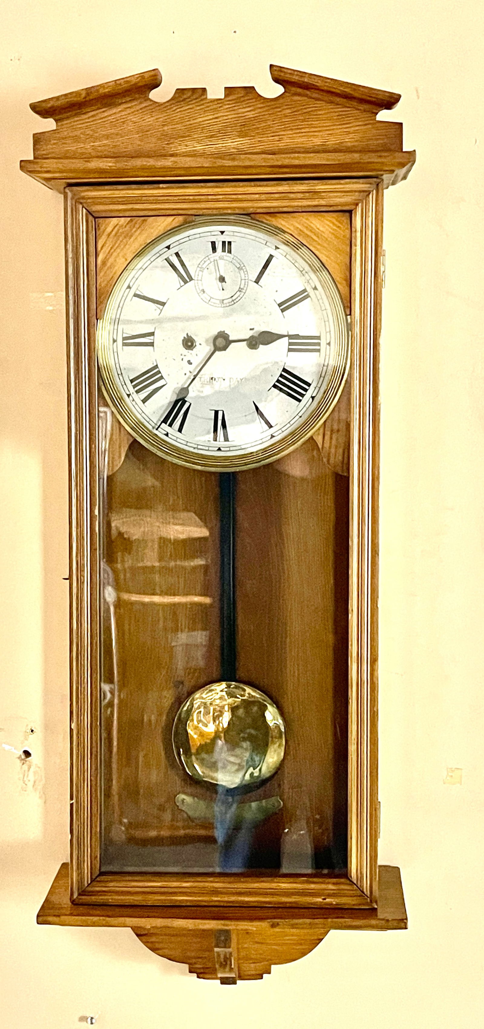 New Haven Oak Regulator Wall Clock: With second hand, time only, 9" dial, clock is complete, USA, 39"t x 6"d x 15"d, circa 1900.