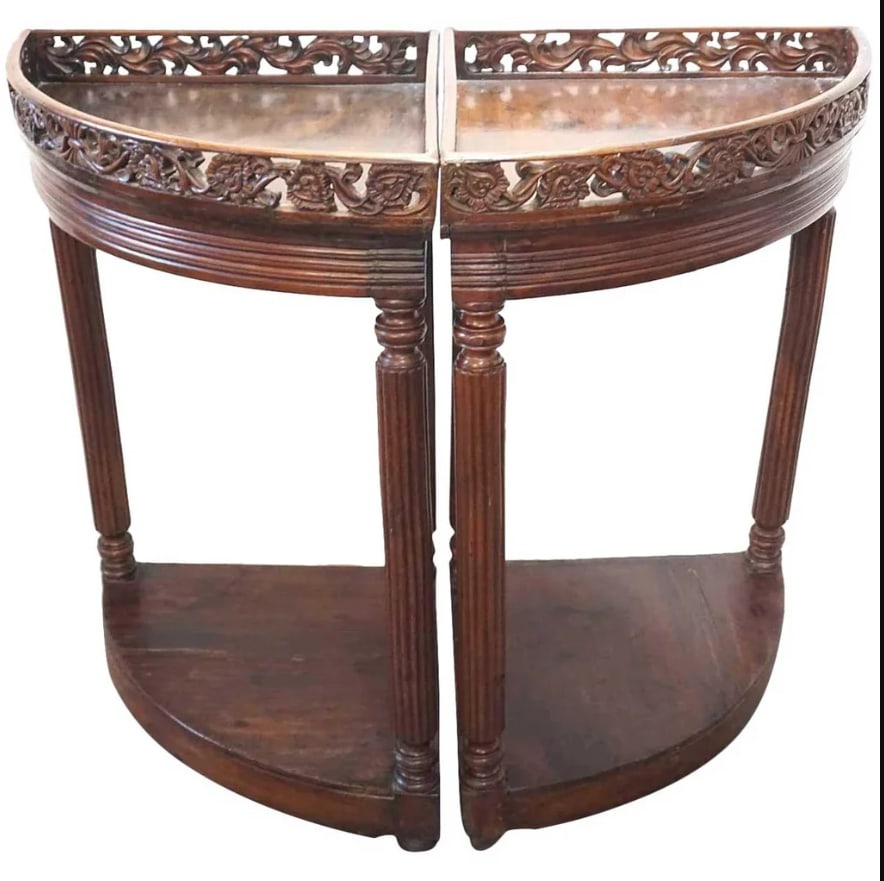 Pair of Indo-Portuguese Mahogany Corner Tables 19th century: Pair of Indo-Portuguese Mahogany Corner Gallery Tables. An unusual form, these antique bow-front corner tables feature pierced galleries in foliate designs, atop tall, turned and reeded legs that supp