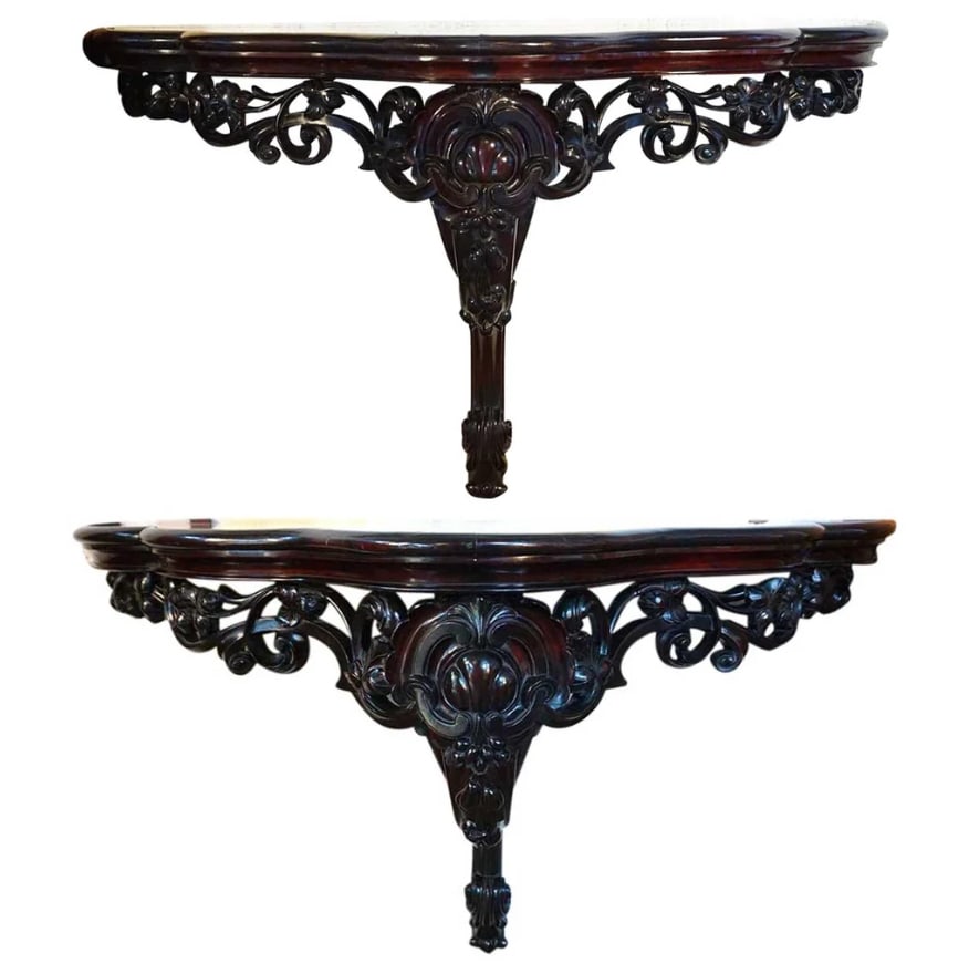 Pair Large Anglo Indian Mahogany Mirrored Top Wall Console Tables: Pair of Anglo Indian Mahogany and Mirrored Top Wall Bracket Consoles. Sporting an ebonized finish, these hand carved, antique, Anglo Indian, 19th century wall console tables were fashioned in a scallo